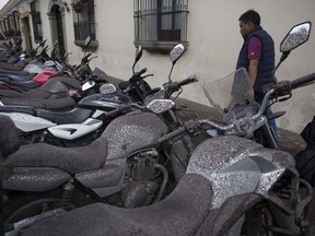 Volcanic ash covers parked motorcycles, brought by the Fuego Volcano, in Antigua Guatemala, Sunday, June 3, 2018. Volcan del Fuego is one of the most active volcanoes in Central America.