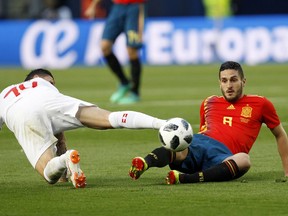 Spain's Koke, right, fights for the ball with Switzerland's Blerim Dzemili during the friendly soccer match between Spain and Switzerland at the Ceramica stadium in Villarreal, Spain, Sunday, June 3, 2018.