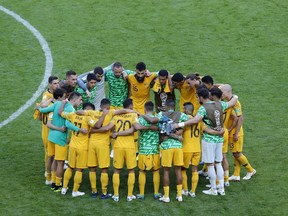 Australia's Mile Jedinak, center, speaks with his teammates after the group C match between France and Australia at the 2018 soccer World Cup in the Kazan Arena in Kazan, Russia, Saturday, June 16, 2018.