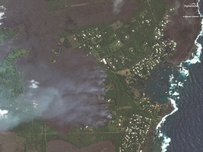This satellite image provided by Digital Globe captured June 3, 2018, shows advancing lava flows on Hawaii as they approach Kapoho Bay and the Vacationland residential neighborhood.  Lava from the erupting Hawaii volcano has destroyed more than 100 homes in a rural Big Island district.  Hawaii County spokeswoman Janet Snyder says as of Monday, June 4, 2018, lava burned down 117 homes. Snyder says that's up from Friday's count of 87.  (Satellite Image ©2018 DigitalGlobe, a Maxar company via AP)