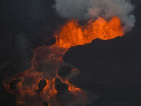 The Kilauea Volcano east rift zone eruption continues mainly from a fissure and forms a river of lava flowing down to Kapoho on Sunday, June 10, 2018, in Pahoa, Hawaii.