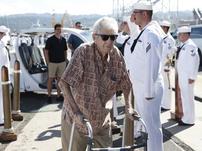 Pearl Harbor survivor Ray Emory, center, arrives a surprise ceremony honoring him, Tuesday, June 19, 2018, in Honolulu. Emory, who served aboard the USS Honolulu during the 1941 attack, is moving back the the mainland and wanted to visit the site where his former ship was moored one last time.