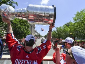 Washington Capitals captain Alex Ovechkin hoists the Stanley Cup at the team's championship victory parade on June 13.