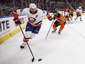 In this March 8 file photo, New York Islanders forward John Tavares controls the puck against the Edmonton Oilers.