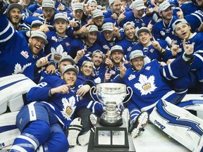 The Toronto Marlies celebrate with the Calder Cup after rolling past the Texas Stars 6-1 in Game 7 of the AHL championship series on Thursday night at Ricoh Coliseum in Toronto.