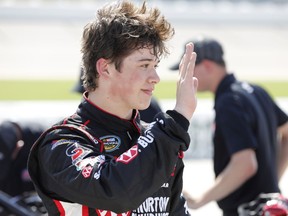 Harrison Burton reacts with crew members after winning the pole position for the NASCAR Truck Series auto race, Saturday, June 16, 2018, at Iowa Speedway in Newton, Iowa.