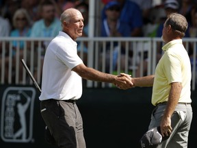 Tom Lehman, left, greets Jerry Kelly after completing their second round of the PGA Tour Champions Principal Charity Classic golf tournament, Saturday, June 9, 2018, in Des Moines, Iowa.