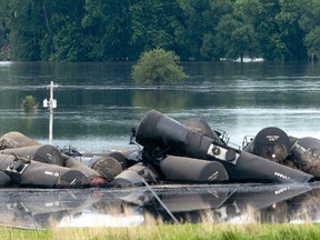 Tank cars carrying crude oil are shown derailed about a mile south of Doon, Iowa, Friday, June 22, 2018. About 31 cars derailed after the tracks reportedly collapsed due to saturation from flood waters from adjacent Little Rock River.