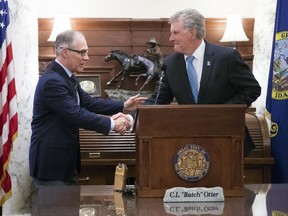 Scott Pruitt, left, administrator of the U.S. Environmental Protection Agency, meets with Idaho Gov. Butch Otter at the Idaho Statehouse Tuesday, June 5, 2018 in Boise, Idaho. Idaho will take over regulating pollution discharge into the state's lakes and rivers from the federal government under an agreement signed Tuesday by the head of the U.S. Environmental Protection Agency.