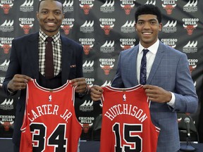 The Chicago Bulls first round draft picks, Wendell Carter Jr., left, and Chandler Hutchison pose with their jerseys after an NBA basketball news conference where they were introduced to Chicago reporters Monday, June 25, 2018, in Chicago.