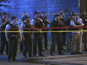 In this Wednesday, June 6, 2018 photo, Chicago Police remain at the scene of a shooting near 47th Street and Prairie Avenue in Chicago.