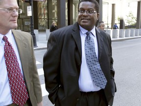 In this Oct. 9, 2013 photo, former Chicago Police Sgt. Ronald Watts, right, leaves the Dirksen U.S. Courthouse  after being sentenced to 22 months in prison. Chicago has paid out more than $650 million in police misconduct cases over the past 15 years or so, and that expenditure is expected to increase yet more. In recent months, a growing roster of men who contend they were framed by former Detective Reynaldo Guevara for murders they didn't commit or by Watts on trumped up drug charges are seeing their convictions and are suing the city.