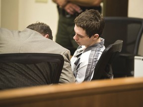 Suspected Dixon High School shooter Mathew Milby speaks with his attorney Thursday, June 7, 2018, during a hearing on his case in Lee County court in Dixon, Ill.