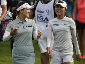 Lydia Ko, right, of New Zealand, smiles as she listens to So Yeon Ryu, of South Korea, as they walk to the ninth hole during the first round of the KPMG Women's PGA Championship golf tournament at Kemper Lakes Golf Club near Kildeer, Ill., Thursday, June 28, 2018.