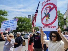 Demonstrators line up to protest U.S. Attorney General Jeff Sessions and immigration reform at Parkview Field in Fort Wayne, Ind. Thursday, June 14, 2018.