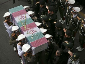 Iranian policemen carry a flag-draped coffin of their colleague, who was one of three policemen killed when a bus rammed into a group of police officers at a protest by followers of a Sufi Islamic leader, during his funeral ceremony, in Tehran, Iran. Mohammad Salas, a member of a Sufi order, who rammed the bus into police was hanged early Monday, June 18, 2018, according to the official website of the judiciary.