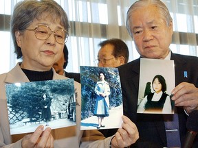 Shigeru (L) Sakie Yokota, parents of Megumi Yokota, who was abducted to North Korean in 1977, shows portrait of their daughter which was brought back by Japanese delegates from North Korea at a press conference in Tokyo 16 November 2004.