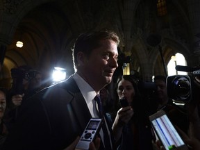 Conservative leader Andrew Scheer makes his way past reporters as he leaves a caucus meeting on Parliament Hill in Ottawa on Wednesday, June 13, 2018.