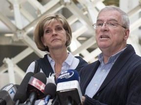 Raymond Bissonnette, father of Alexandre Bissonnette, who pleaded guilty in the 2017 mosque shooting, reads a statement to media as the shooter's mother, Manon Marchand, looks on, Thursday, June 21, 2018 at the hall of justice in Quebec City.