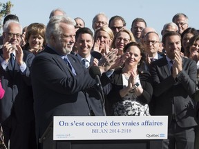 Quebec Premier Philippe Couillard, left, is applauds along with members of his caucus during a news conference marking the end of the session, Friday, June 15, 2018 in Quebec City.