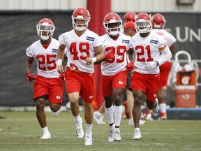 Kansas City Chiefs defensive backs Armani Watts (25), Daniel Sorensen (49), Tremon Smith (39) and cornerback Eric Murray (21) run during the team's NFL football practice Tuesday, June 12, 2018, in Kansas City, Mo.