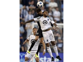 Minnesota United forward Alexi Gomez (32) heads the ball against Sporting Kansas City midfielder Ilie Sanchez, back, during the first half of an MLS soccer match in Kansas City, Kan., Sunday, June 3, 2018.