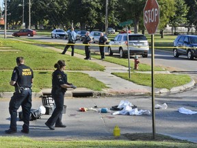 FILE - In this Sept. 28, 2017, file photo, Topeka, Kan., police officers walk near the location where Dominique White was shot and killed in an officer-involved shooting in Topeka, Kan. White's family filed a federal civil rights lawsuit against the city and police Wednesday, June 27, 2018, alleging that the two white officers involved in the shooting lacked legal justification when they fatally shot White after a struggle near a park in Topeka.