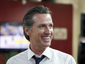 FILE - In this May 31, 2018 file photo Democratic Lt. Gov. Gavin Newsom smiles at a campaign stop at Stakely's Barber Salon in Los Angeles. Newson is expected to easily top the field in the race for govenor, but former Los Angeles Antonio Villaraigosa and state Treasurer John Chiang are among the Democrats hoping to box out Republican John Cox and make it a one-party showdown in November for the state's highest office.