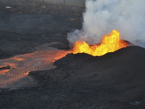 This photo provided by the U.S. Geological Survey shows lava fountaining at a fissure near Pahoa on the island of Hawaii Tuesday, June 5, 2018. Lava from Hawaii's Kilauea volcano destroyed hundreds more homes overnight, overtaking two oceanfront communities where residents were advised to evacuate last week, officials said Tuesday.  (U.S. Geological Survey via AP)