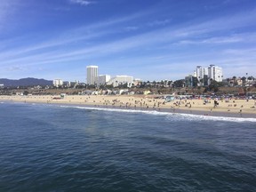 In this photo taken March 18, 2018, the ocean and beach are viewed from the pier in Santa Monica, Calif. An annual "Beach Report Card," released Thursday, June 7, 2018, concludes that low rainfall in California is resulting in less runoff and cleaner water along the coast. Heal The Bay said that a record 37 beaches statewide made its Honor Roll, meaning they are monitored year-round and score perfect A-plus grades each week.