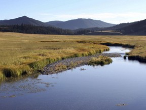 FILE - In this Sept. 3, 2010, file photo, the East Fork of the Jemez River cuts through Valles Caldera National Preserve, in N.M. Underground pockets of boiling water and steam that could have been tapped to produce electricity are now off limits as the Santa Fe National Forest that borders Valles Caldera National Preserve in northern New Mexico has said no to the prospect of geothermal development.