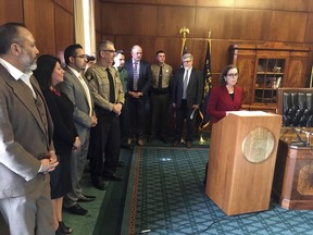 FILE - In this Feb. 2, 2017 file photo Oregon Gov. Kate Brown speaks during a news conference in the Capitol ceremonial office in Salem, Ore. Brown is asking Oregon's attorney general to bring legal action against the federal government over President Donald Trump's executive order on immigration. A conservative group is taking aim at the nation's oldest statewide sanctuary law, with a drive to repeal a 31-year-old Oregon mandate limiting police coordination on immigration arrests.
