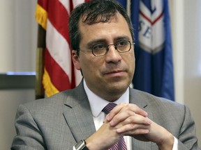 FILE - In this Dec. 13, 2017 file photo, L. Francis Cissna, director of U.S. Citizenship and Immigration Services, sits during an interview in Los Angeles. The U.S. government agency that oversees immigrants' applications to become citizens is starting an office tasked with stripping naturalized Americans of their citizenship if they cheated to get it. Cissna said in an interview Friday, June 8, 2018, that his agency is hiring several dozen lawyers and officers to review the cases of immigrants who were ordered deported and are suspected of using fake identities to later get green cards and naturalize.