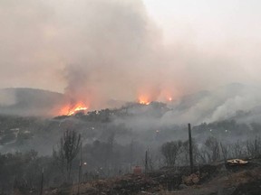 In this photo provided by the California Department of Forestry and Fire Protection, the Pawnee Fire wildfire burns in the Spring Valley area, northeast of Clearlake Oaks in Lake County, Calif., early Sunday, June 24, 2018. The Pawnee Fire, which broke out Saturday near Clearlake Oaks, was one of four wildfires burning in largely rural areas as wind and heat gripped a swath of California from San Jose to the Oregon border.