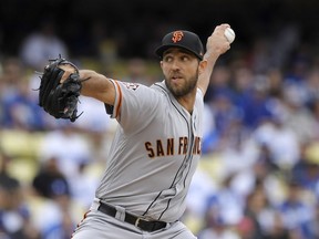 San Francisco Giants starting pitcher Madison Bumgarner throws to the plate during the first inning of a baseball game against the Los Angeles Dodgers, Saturday, June 16, 2018, in Los Angeles.