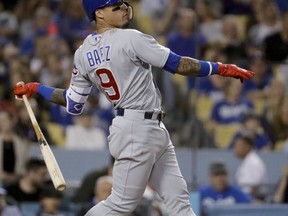 Chicago Cubs' Javier Baez watches his home run against the Los Angeles Dodgers during the fifth inning of a baseball game in Los Angeles, Tuesday, June 26, 2018.