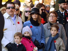 The family of Brett Cameron, who died at Royal Military College in May 2016 - Bill and Angela Jolly with children, Max, Rowan and Liam - wait for a Remembrance Day ceremony to begin at the Cenotaph in Victoria Park in London, Ont. on Friday November 11, 2016.