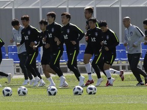 South Korean national soccer team players run during a training session of South Korea at the 2018 soccer World Cup at the Spartak Stadium in Lomonosov near St. Petersburg, Russia, Wednesday, June 20, 2018.