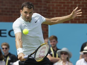 Grigor Dimitrov of Bulgaria plays a return to Damir Dzumhur of Bosnia and Herzegovina during their singles tennis match at the Queen's Club tennis tournament in London, Tuesday, June 19, 2018.