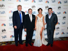 FILE - In this Sunday, June 16, 2013 file photo, from left, Donald Trump, Aras Agalarov, Miss Universe 2012 Olivia Culpo and Russian singer Emin Agalarov arrive at the Miss USA 2013 pageant, in Las Vegas. Donald Trump in a hotel room with bikini-clad beauty contestants, a suspicious-looking suitcase changing hands, Ivanka Trump clinking glasses with Hillary Clinton - all under the gaze of security agents. That's all in a music video by Russian pop star Emin Agalarov, who was named in the U.S. investigation into Russian interference in the 2016 election.