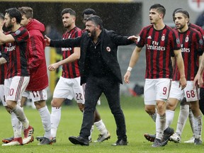 FILE - In this Sunday, March 18, 2018 file photo, AC Milan coach Gennaro Gattuso celebrates with his players after winning the Serie A soccer match between AC Milan and Chievo Verona at the San Siro stadium in Milan, Italy. UEFA has on Wednesday, June 27, 2018 given AC Milan a one-year Europa League ban for overspending on player transfer and wages. Milan last year spent more than 200 million euros (then nearly $250 million) on new players amid questions over the financial stability of the Chinese-led consortium that purchased the Italian club from Silvio Berlusconi for $800 million in April 2017.