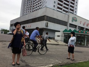 Residents go about their business near one of the city's biggest department stores and shopping areas in Pyongyang, North Korea Sunday, June 10, 2018. Despite the focus of world attention on the upcoming summit in Singapore between US President Donald Trump and North Korean leader Kim Jong Un, many North Koreans remain in the dark about what is happening outside their isolated nation.