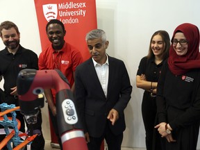 Mayor of London Sadiq Khan looks at exhibits during London Tech Week in London, Monday, June 11 2018. London Mayor Sadiq Khan says he hopes U.S. President Donald Trump will reconsider the protectionist measures that divided the G-7 summit in Canada last weekend.