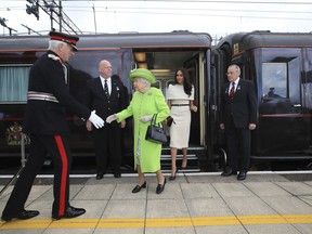 Britain's Queen Elizabeth II and Meghan, the Duchess of Sussex arrive by Royal Train at Runcorn Station, north west England, Thursday June 14, 2018.
