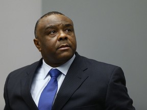 FILE - In this June 21, 2016 file photo, former Congolese Vice President Jean-Pierre Bemba enters the courtroom of the International Criminal Court in The Hague, Netherlands. International Criminal Court appeals judges overturned Friday, June 8, 2018 the convictions of former Congolese Vice President Jean-Pierre Bemba for atrocities committed by his forces in Central African Republic. The reversal delivered a serious blow to ICC prosecutors by scrapping all the convictions in the court's first trial to focus largely on sexual violence and on command responsibility - the legal principle that a commanding officer can be held responsible for crimes committed by his or her troops or for failing to prevent or punish the crimes.