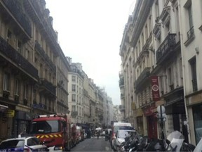 In this image from TV, Emergency services attend the scene after a man took hostages in Paris, Tuesday June 12, 2018. Several people are being held hostage in Paris after an armed man stormed a building in the capital's 10th district. (AP Photo)