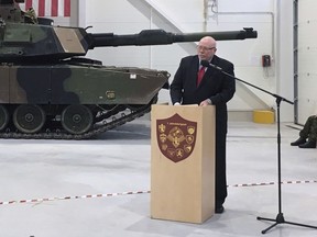 FILE: In this Thursday, Dec. 15, 2016 file photo, U.S. Ambassador to Estonia James D. Melville Jr. addresses dignitaries in front of an U.S. Army tank, at a hand-over ceremony of the upgraded NATO military base in Tapa, Estonia. The U.S. ambassador to Estonia says he has resigned over frustrations with President Donald Trump's comments about the European Union and the treatment of Washington's European allies