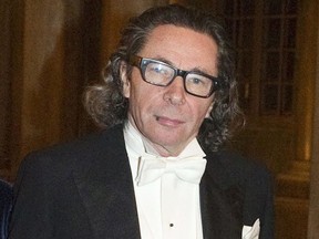 FILE - In this Dec. 11, 2011 file photo, photographer Jean Claude Arnault attends the Kings Nobel dinner at the Royal Palace in Stockholm. The man at the center of a sex-abuse and financial crimes scandal that is tarnishing the academy which awards the Nobel Prize in Literature, was Tuesday June 12, 2018 charged with two counts of rape of a woman in 2011.