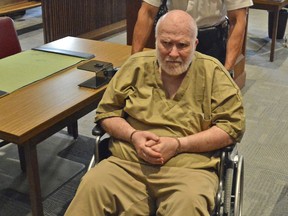 A court officer pushes convicted child rapist Wayne Chapman in the court room at his arraignment on Wednesday, June 6, 2018, in Ayer, Mass. Chapman, who was set to be released from custody after two experts concluded he was no longer "sexually dangerous" will remain locked up after he was arrested Wednesday for indecent exposure and lewd acts, authorities said.