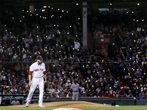 Fans turn on the flashlight on their cellphones as Boston Red Sox relief pitcher Matt Barnes walks back to the mound during the seventh inning of the team's baseball game against the Detroit Tigers at Fenway Park in Boston, Wednesday, June 6, 2018.